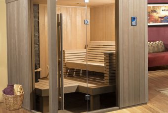 A traditional sauna for sale with a comfortable bench for you and your partner.