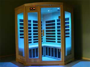 Compact sized infrared sauna for sale installed in a room with modern furniture and decorations.